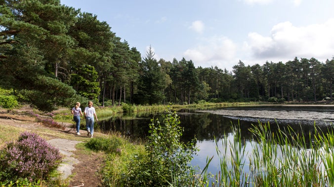 Two girls walking along the banks of the Nelly's Moss lakes